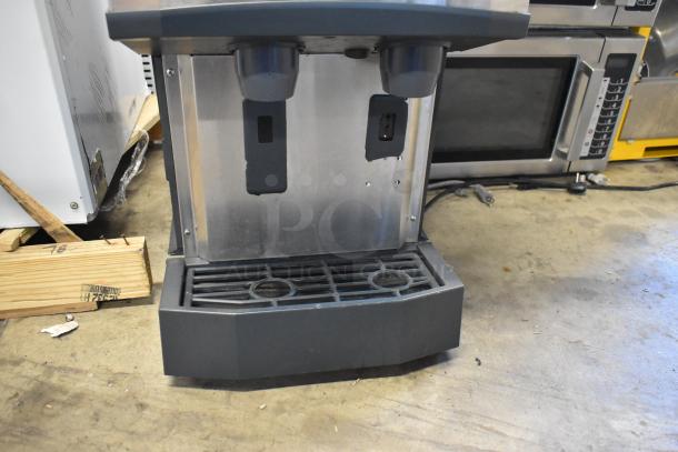 Scotsman HID312A-1A stainless steel countertop ice machine and water dispenser with 12 lb. bin, new condition, visible minor dents.