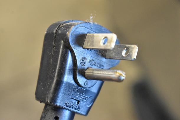 Plug of Scotsman HID312A-1A ice machine and water dispenser, black with certification markings.