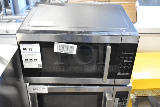 Hamilton Beach HB8436127995-03 countertop microwave, 120 volts, 1 phase, control panel, and barcode label visible.
