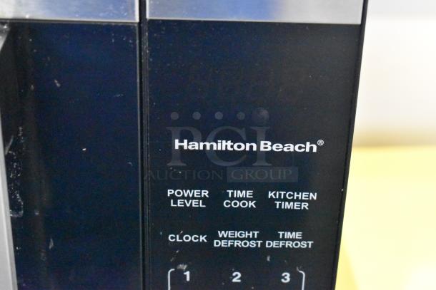 Hamilton Beach HB8436127995-03 Countertop Microwave Oven, black panel, showing brand name and control options.