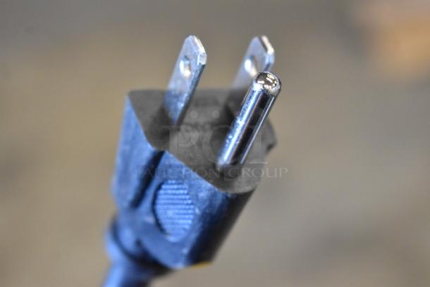 Close-up of a three-prong plug from the 2025 Hamilton Beach HB8436127995-03 Countertop Microwave Oven, 120V, 1 Phase.