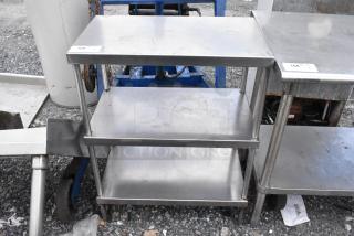 Stainless steel table with 2 under shelves, industrial design, used condition.