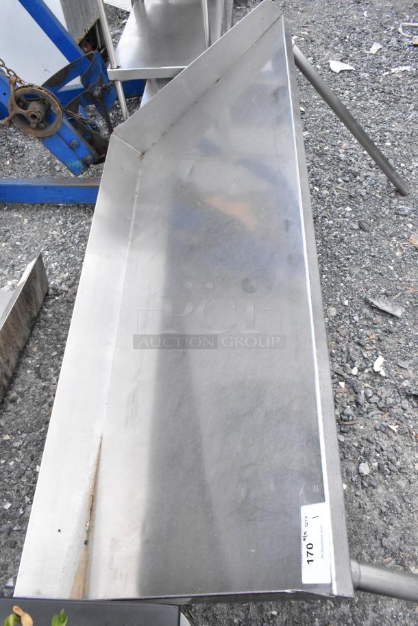 Stainless steel shelf, rectangular, slightly worn, with a visible tag labeled "170 QTY 1." Solid construction.