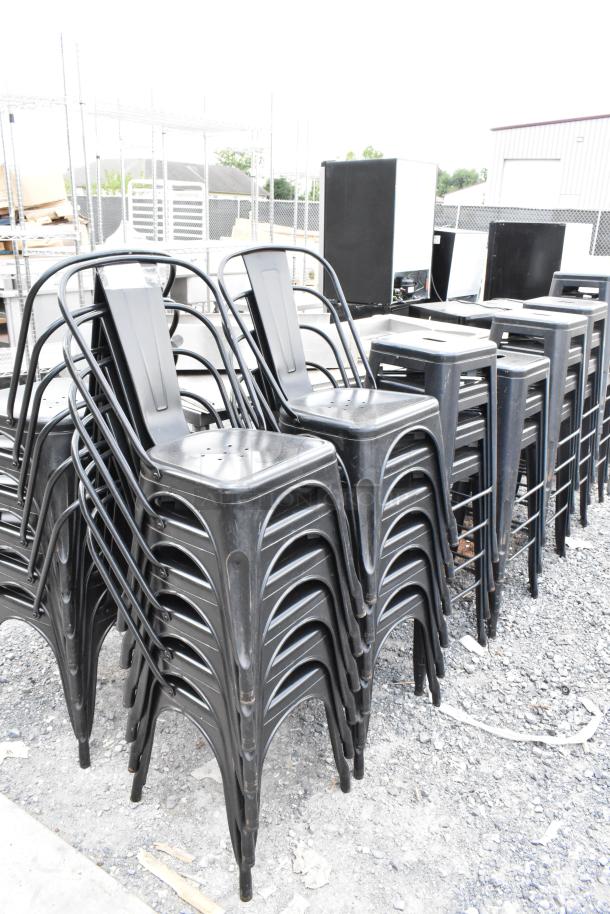 38 black metal Tolix style chairs and bar stools in good condition, stacked for bulk sale.