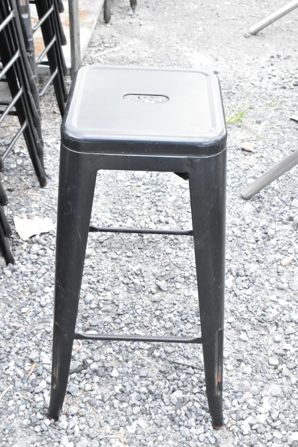 Set of black metal Tolix style chairs and bar stools. Industrial design, good condition, stackable, minimalist aesthetic.