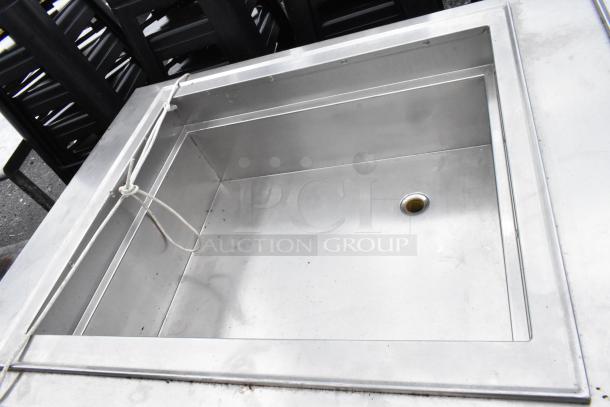 Stainless steel 2-well food warmer station with under shelf, showing clean, spacious wells and drain, in good condition.