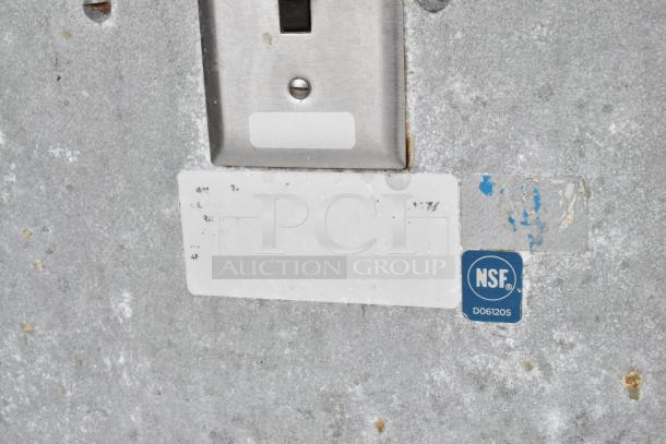Stainless steel food warmer station with NSF label, 2 wells, under shelf; visible wear, wall-mounted switch.