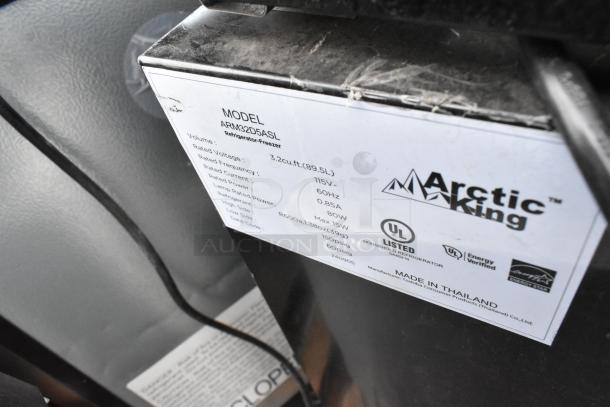 Label on Arctic King ARM32D5ASL mini cooler showing specs: 3.2 cu.ft., 115V, 60Hz, R600a refrigerant. UL listed. Made in Thailand.