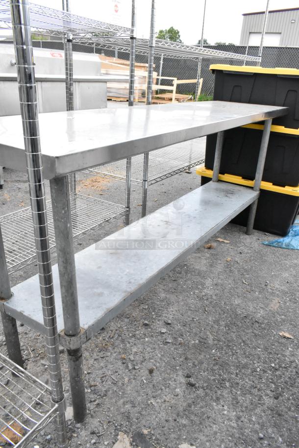 Stainless steel table with metal under shelf, industrial use, sturdy condition, ideal for storage or workspace.