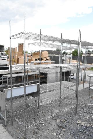 Chrome finish 3-tier wire shelving unit, outdoor setting, sturdy metal construction, buyer must dismantle for shipping.