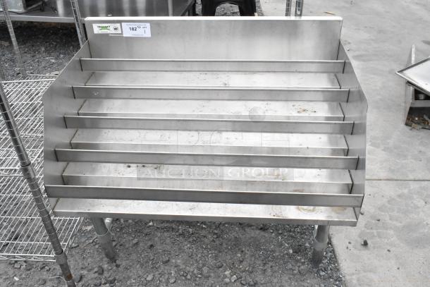 Regency 600LDR2336 stainless steel bottle display rack, five-tier, used condition, NSF certified sticker visible.