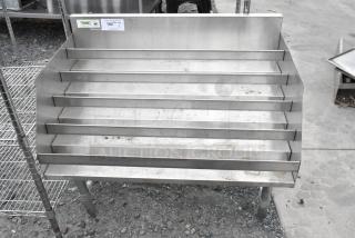 Regency 600LDR2336 stainless steel bottle display rack, five-tier, used condition, NSF certified sticker visible.