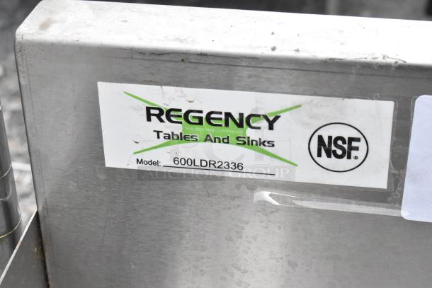 Regency 600LDR2336 stainless steel bottle display rack, NSF certified, shows brand label with model number.