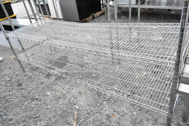 Chrome finish 4-tier wire shelving unit with sturdy metal frame. Buyer must dismantle. Ideal for storage, consider freight costs.