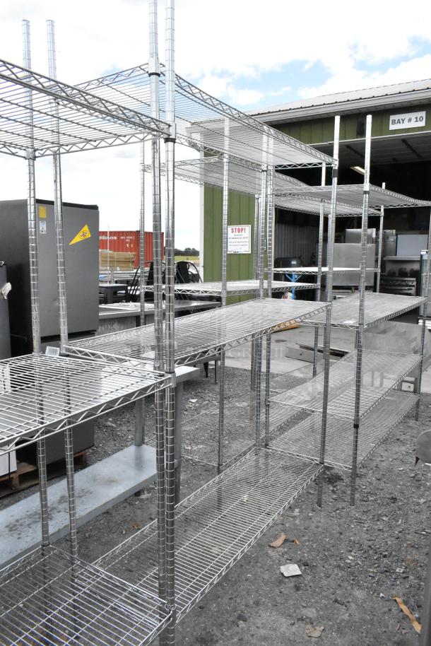 Chrome finish 3-tier wire shelving unit, outdoor setting, buyer must dismantle. Ideal for warehouse or storage use.