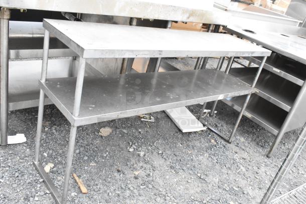 Stainless steel 2-tier over shelf, used condition, featuring durable construction and space-saving design for kitchen organization.