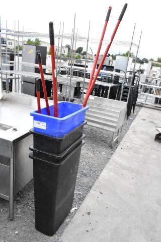 Four Poly Slim Jim trash cans with red-handled brooms, stacked, used condition, visible labels show quantity details.