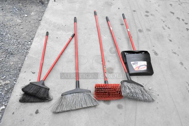 Four brooms and a dustpan with red handles, included in 4 Poly Slim Jim trash cans auction. Various bristle styles visible.