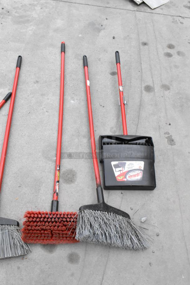 Four brooms with red handles, including a Libman dustpan, on concrete. Part of contents for 4 Poly Slim Jim trash cans.