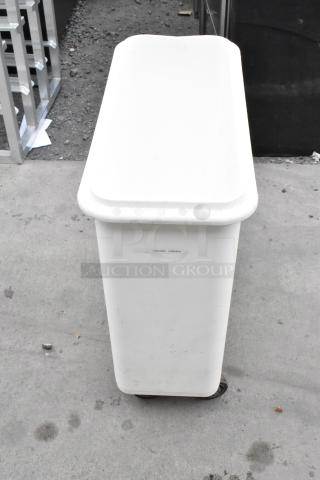 White poly ingredient bin on commercial casters, used condition, features label, suitable for kitchen storage.