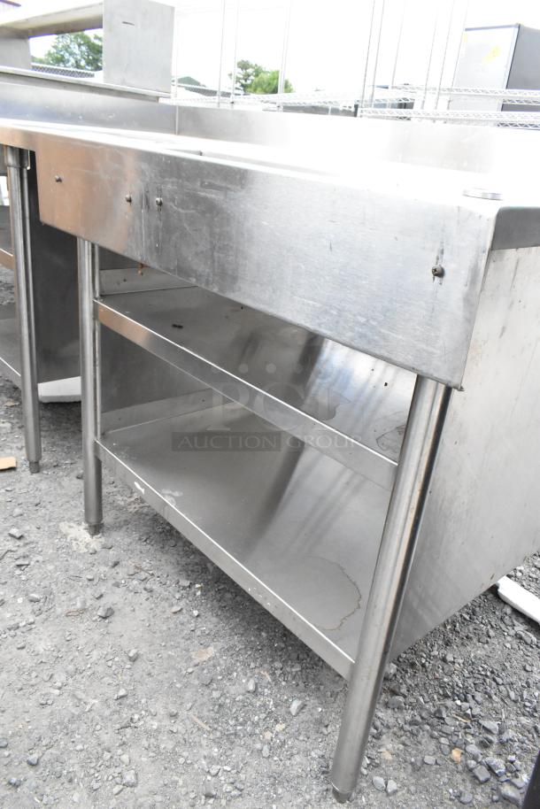 Stainless steel commercial soda station with under shelves, used condition. Suitable for professional beverage service.