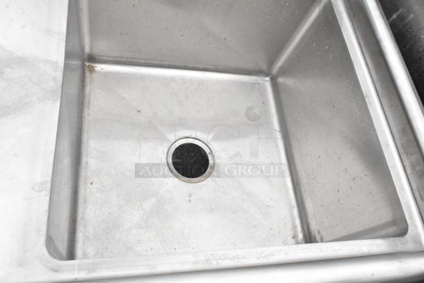 Yukon stainless steel commercial single bay sink with left side drain board, clean condition, slight wear visible.