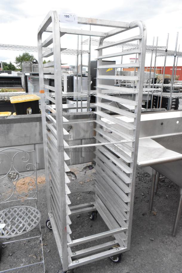 Metal commercial pan transport rack with adjustable shelves, on sturdy casters. Good condition, ideal for kitchen use.