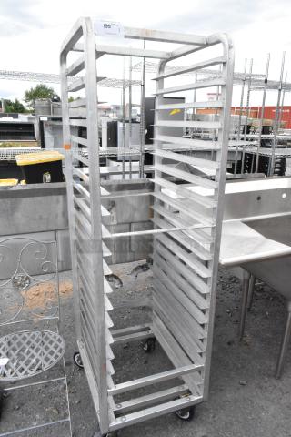 Metal commercial pan transport rack with adjustable shelves, on sturdy casters. Good condition, ideal for kitchen use.