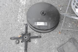 Lot of 2 table base feet plates and 1 top base piece. Plate has label "196 QTY". Black finish, minor wear visible.