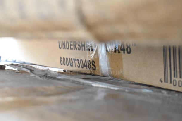 Cardboard box labeled "600UT3048S" on pallet, part of a 32-item scratch and dent auction lot including wire shelves and kits.