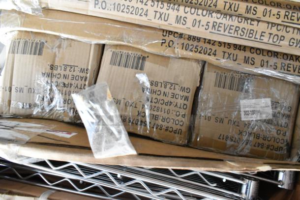 Boxes of scratch and dent items, including Regency 24" x 72" wire shelf, displaying labels and barcodes.