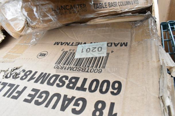 Cardboard boxes labeled "18 Gauge" and "Lancaster Table & Seating," with visible barcode and shipping label. Boxes show wear.