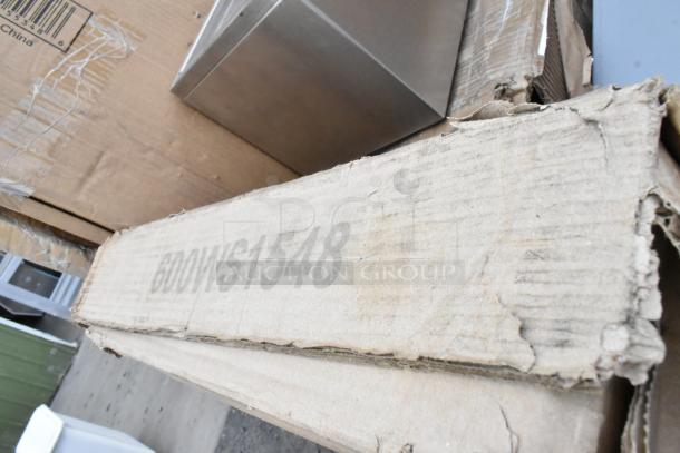 Cardboard box labeled "600WS1548," showing signs of wear, part of a scratch and dent auction lot.