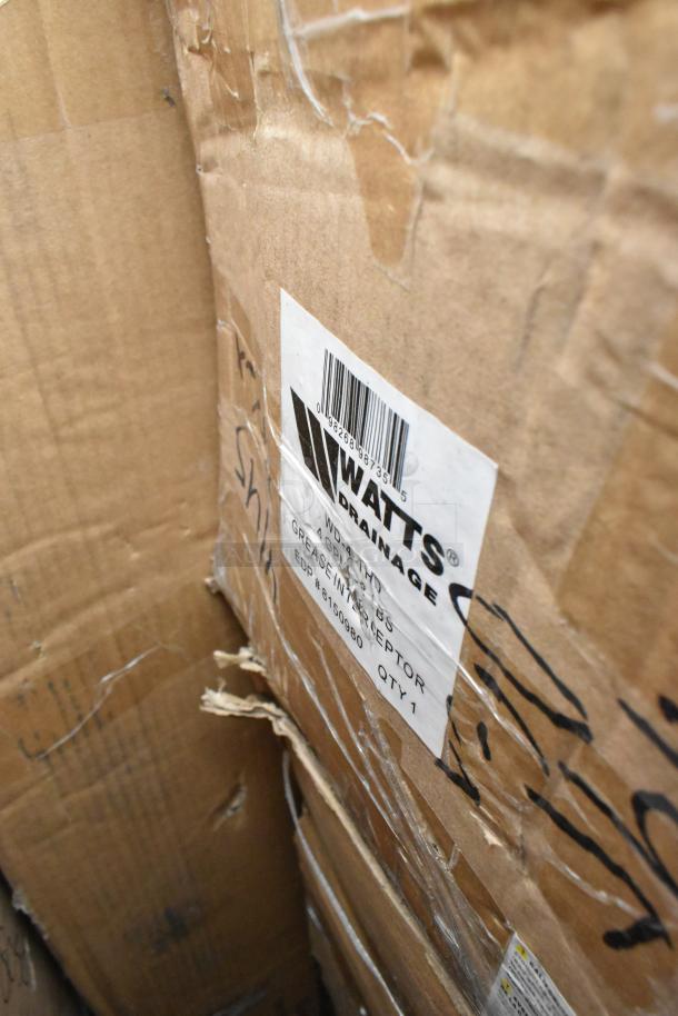 Cardboard box with visible label showing Watts WD-4-THD Grease Trap, indicating one of the 20 brand new scratch and dent items.