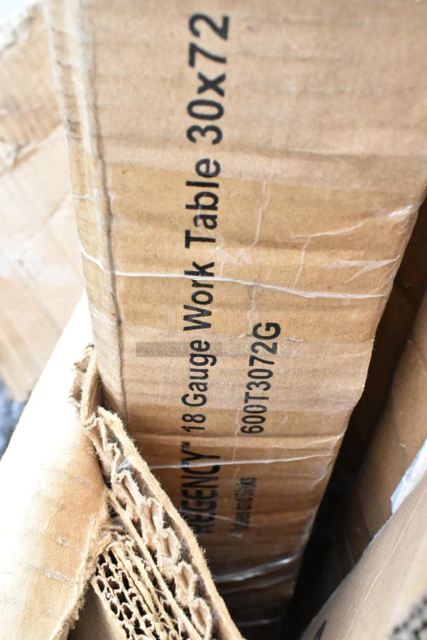 Box containing a Regency 18 Gauge Work Table, labeled "30x72", visible through partly opened packaging cardboard.