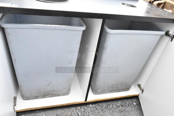 Black trash can shell with two trash deposit holes and two removable trash cans, used condition.
