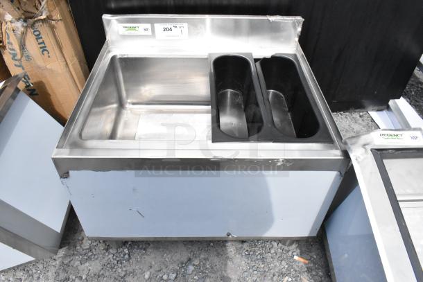 Regency 600IB2124C7 stainless steel ice bin with cold plate, scratch and dent. No legs, auction tag visible.