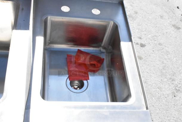 Regency 600CSL2960S stainless steel cocktail station sink with visible dents and two red packages inside.