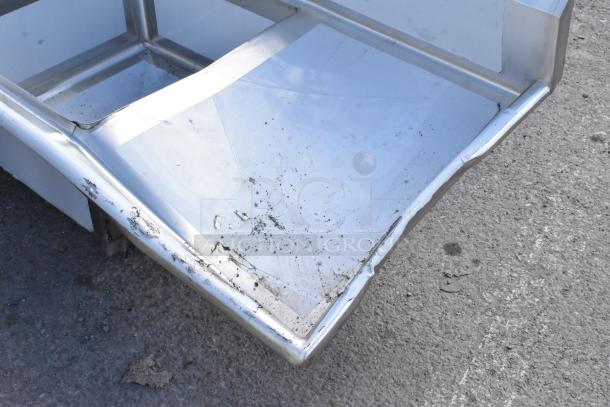 Regency 600S22323224 stainless steel sink with dual drain boards, scratch and dent visible. Brand new condition.