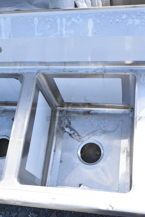 Regency 600S31416212 stainless steel 3-bay sink, scratch and dent, with dual drain boards, no legs, brand new condition.
