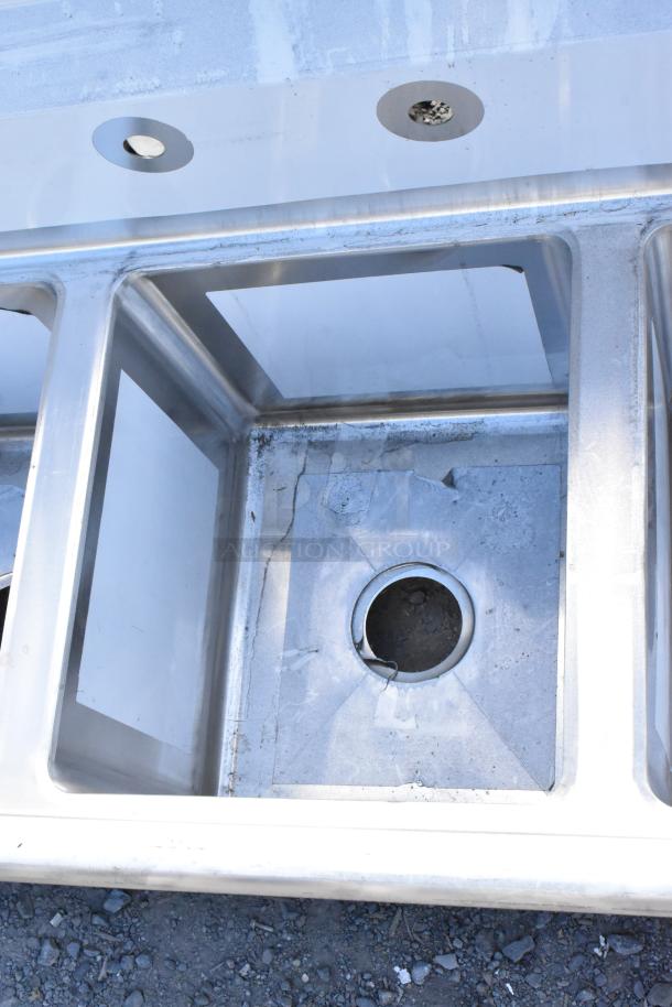 Brand new Regency 600S31416212 stainless steel 3-bay sink with dual drain boards; no legs. Scratch and dent condition.