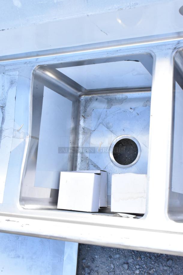 Regency stainless steel 3 bay sink, model 600S31416212, scratch and dent, dual drain boards, no legs.