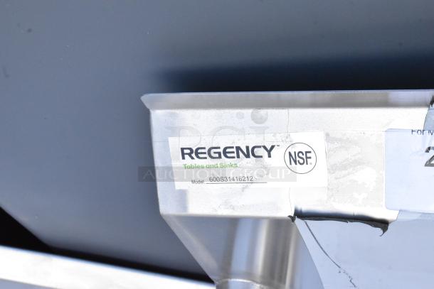 Regency 600S31416212 stainless steel 3-bay sink with dual drain boards, no legs, NSF certified, brand label visible.