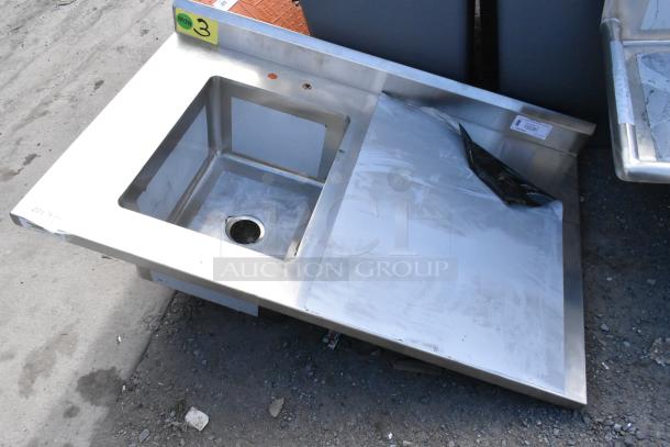 BRAND NEW SCRATCH AND DENT! Regency 600ST3048L stainless steel table with single bay sink basin, no legs, minor surface marks.