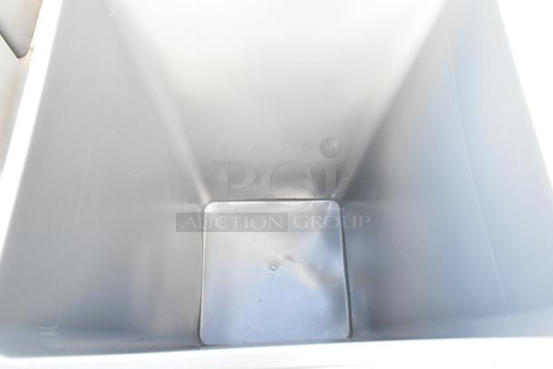 Gray poly trash can, brand new condition with minor scratches and dents, part of lot of 19.