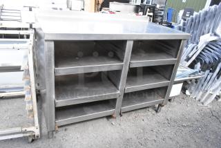 Stainless steel table with under shelves, featuring a durable industrial design. Ideal for kitchens or workshops.