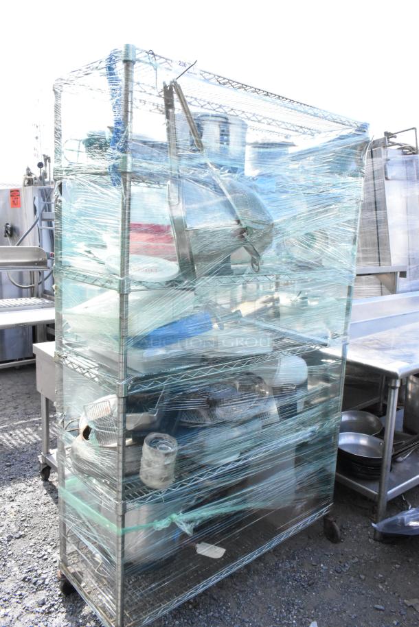 Chrome finish 5-tier wire shelving unit with poly bins, stock pot, Pelouze scale, China cap strainer, and lids. Buyer dismantles.
