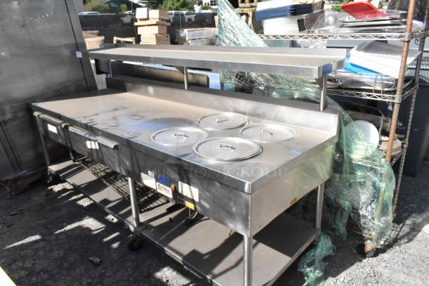 Belshaw stainless steel prep station with over shelf, drawers, under shelf, and commercial casters, used condition.