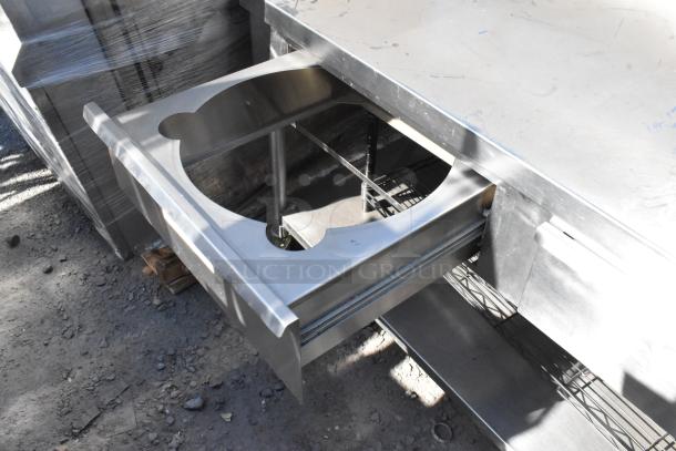 Belshaw stainless steel commercial prep station with over shelf, drawers, and under shelf on casters. Visible minor wear.