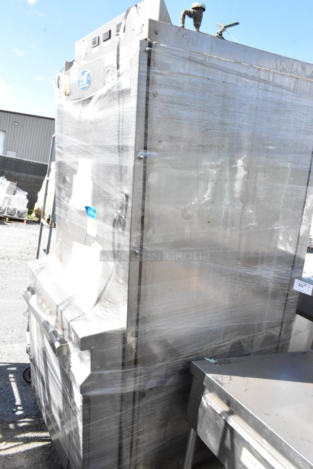 LVO FL14E stainless steel commercial pot and pan washer, front load, 460V, 3 phase, wrapped, outdoor setting visible.